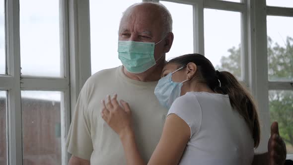 Caucasian Woman In Medical Mask Hugging Old Man Father Supporting And Caring Him