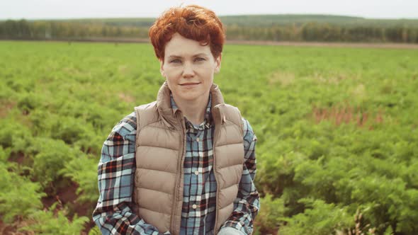 Portrait of Young Redhead Woman on Farm Field