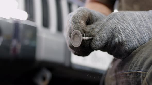 Close Up Mechanic in Car Service Polishes and Cleans Engine Valves By Hand
