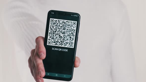 Male Hand Shows QR Code on Smartphone on White Background