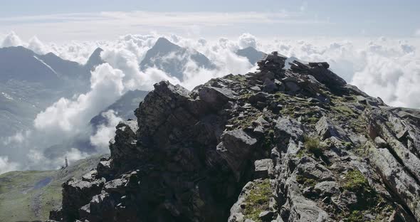 Aerial View of Rocky Mountain Peak in Summer. On the Top of Clouds, Majestic Landscape in Background