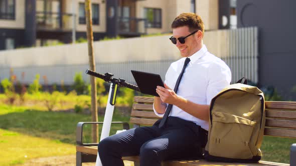 Businessman with Tablet Computer, Bag and Scooter