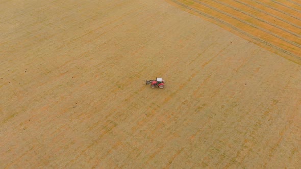 Tractor moving on agricultural field 4k