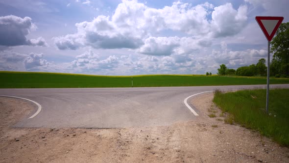 Crossroad of Dirt and Asphalt Road in Summer