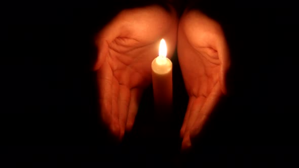 Hands Holding a Burning Candle in Dark 003 alt