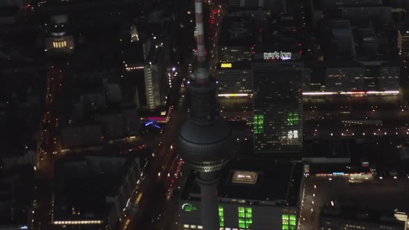 AERIAL: Over Berlin Germany TV Tower Alexanderplatz at Night with City Lights Traffic 