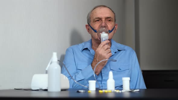 Sick Senior Male Using Nebulizer Treatment