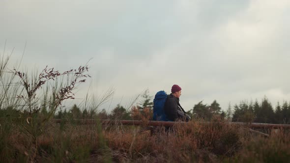 Tourist with Huge Backpack Walks Along the Trail in Himmelbjerget Area Denmark