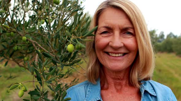 Portrait of happy woman standing in olive farm 4k