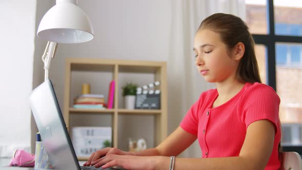 Student Girl with Laptop Computer Learning at Home