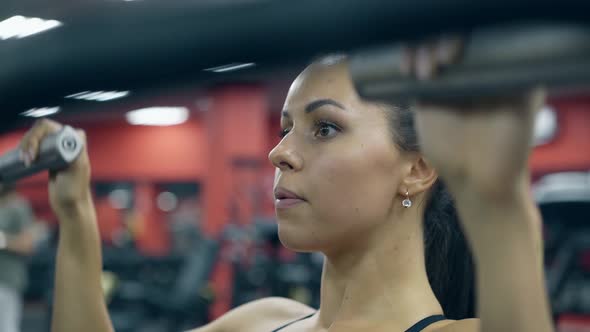 Close Girl with Ponytail Breathes Deeply Doing Exercises