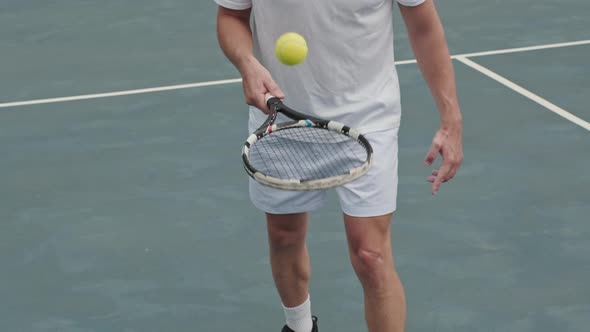 Tennis Player Bouncing Ball on Racket