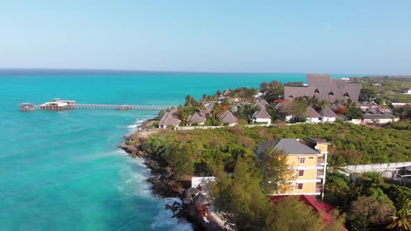 Aerial Tropical Landscape of Zanzibar Waves Hit Reef on Hotels Coastline Palms