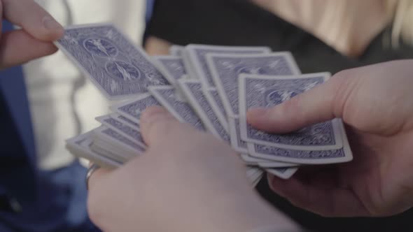 Hands of Man Who Holding a Deck of Cards and Hands of Woman and Other Male Is Pointing on Card