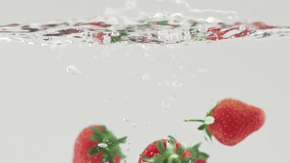 Delicious Strawberry Falling Into Water in Slow Motion Beautiful Commercial Shot