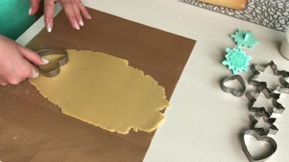 A Woman Works With A Heart Shaped Cookie Dough.