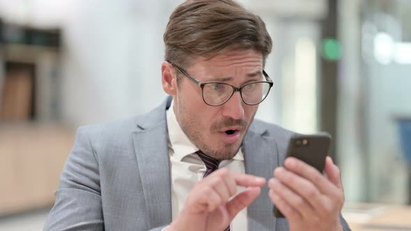 Portrait of Upset Businessman Having Loss on Smartphone 