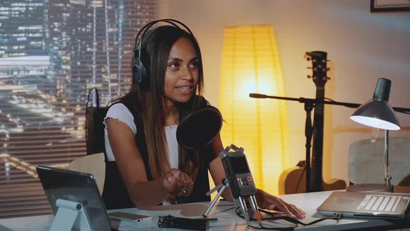 Closeup of Female Radio News Reporter Recording Her Morning Speech in Home Studio