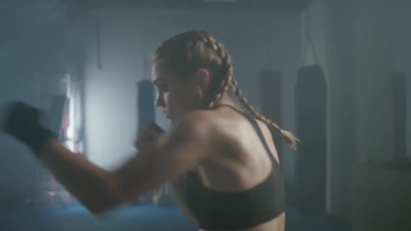Female Fighter Trains His Punches Training in the Boxing Gym Female Trains a Series of Punches Fast