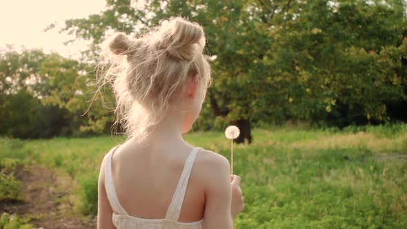 Child Girl Playing With The Dandelion Flower