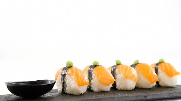 Nigiri sushi served on black stone slate