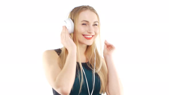 Beautiful Girl Wearing Headphones and Dancing