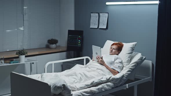 Woman Using Tablet Computer in Hospital Room