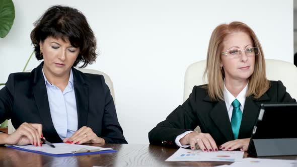 Revealing Shot of Businesswoman Signing a Contract