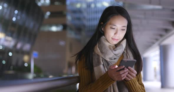 Woman Use of Smart Phone in Hong Kong City at Night