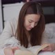 Woman Enjoying Reading on Bed - VideoHive Item for Sale