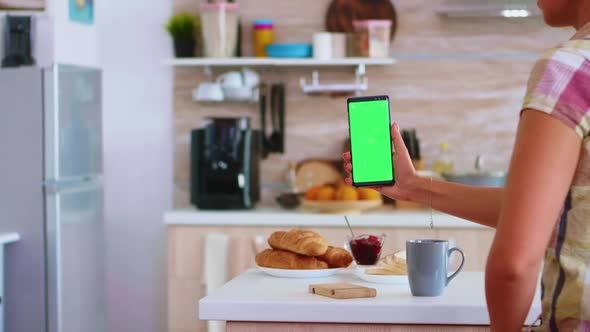 Holding Phone with Green Touch Screen