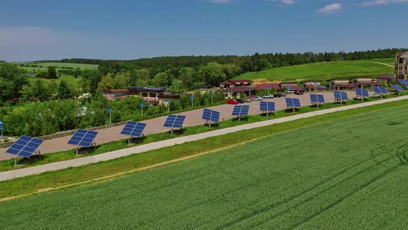 Modern complex with photovoltaic cells. Row of solar panels along the road in nature landscape. 