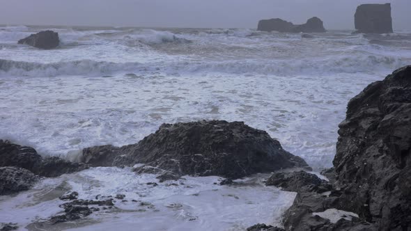 White Surf Crashing Into Rocks And Horizon