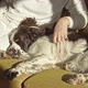A Woman Stroking a Dog on the Couch - VideoHive Item for Sale