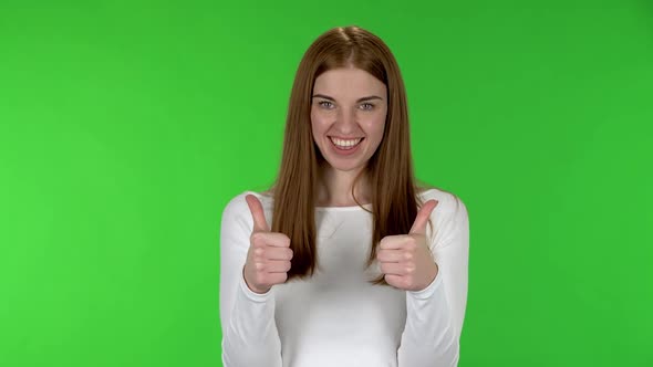 Portrait of Pretty Young Woman Showing Thumbs Up Gesture Like Then Showing Thumbs Down and Smiling