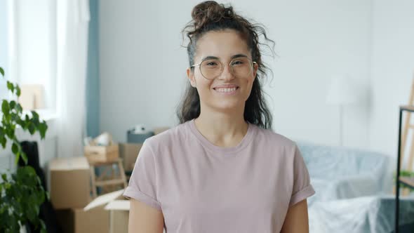 Portrait of Cheerful Asial Woman Smiling Looking at Camera in New Apartment After Relocation