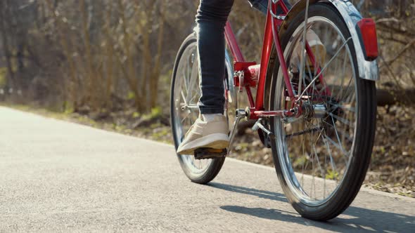 Feet of Girl Riding Bicycle in Park