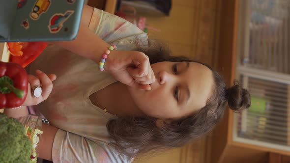 Teen Girl Searching the Recipe on a Digital Tablet in Kitchen