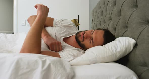 Young man sleeping on his bed