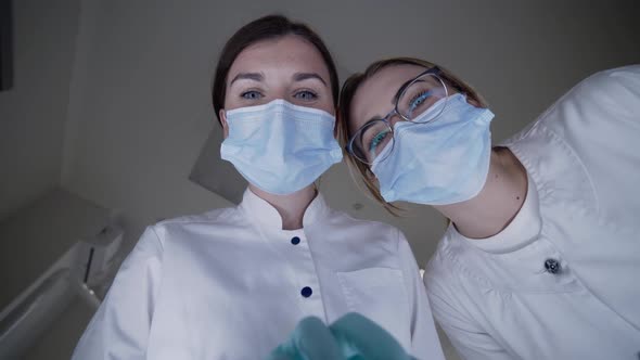 POV Shot of Patient Seeing Female Dentist with Assistant During Treat Procrdure