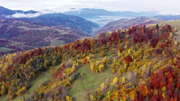 Fly Over Landscapes of Green Hills Under a Layer of White and Fluffy Clouds