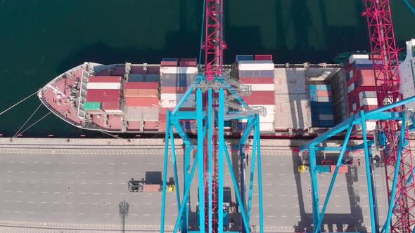 Drone Flying Over a Container Ship During Cargo Operations Over the Customs Area