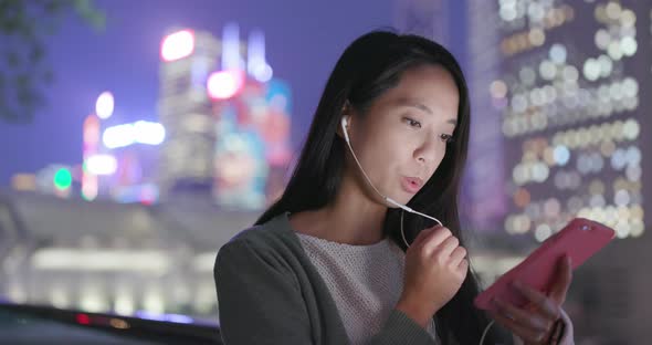 Young Woman using mobile phone to send audio message