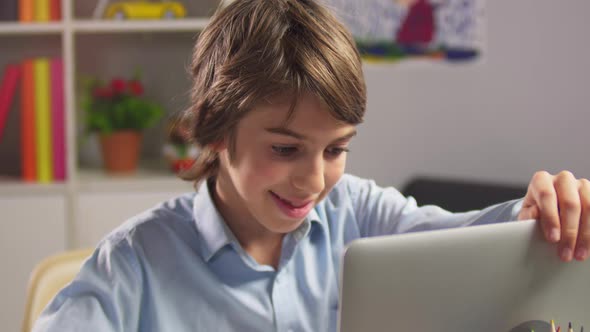 Portrait of Student Boy Opening Laptop Computer