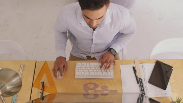 View from above of man working in creative office