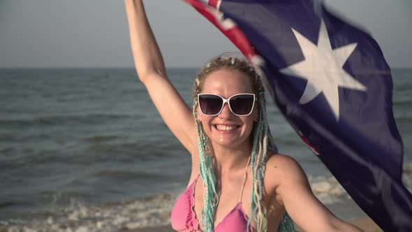 Beautiful Woman with the Flag of Australia at the Seaside