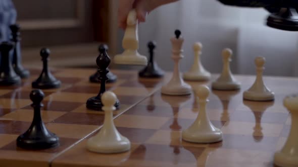 Grandfather teaches his grandson to play chess.Close-up.