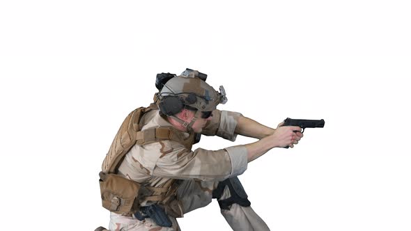 Soldier Is Shooting From Pistol Sitting on His Knee on White Background