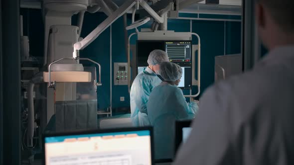 Doctor Watching Surgery Through Window in Lab