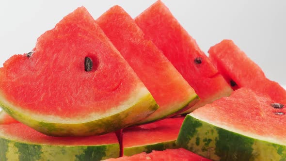 Pile of fresh sliced watermelon on white background.
